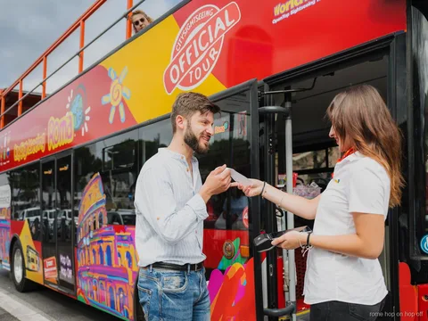 Passengers with headphones on the Rome City Sightseeing hop-on hop-off bus